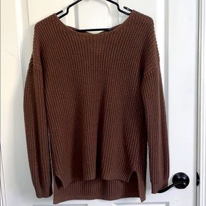 Light brown sweater. Crossed design on the back